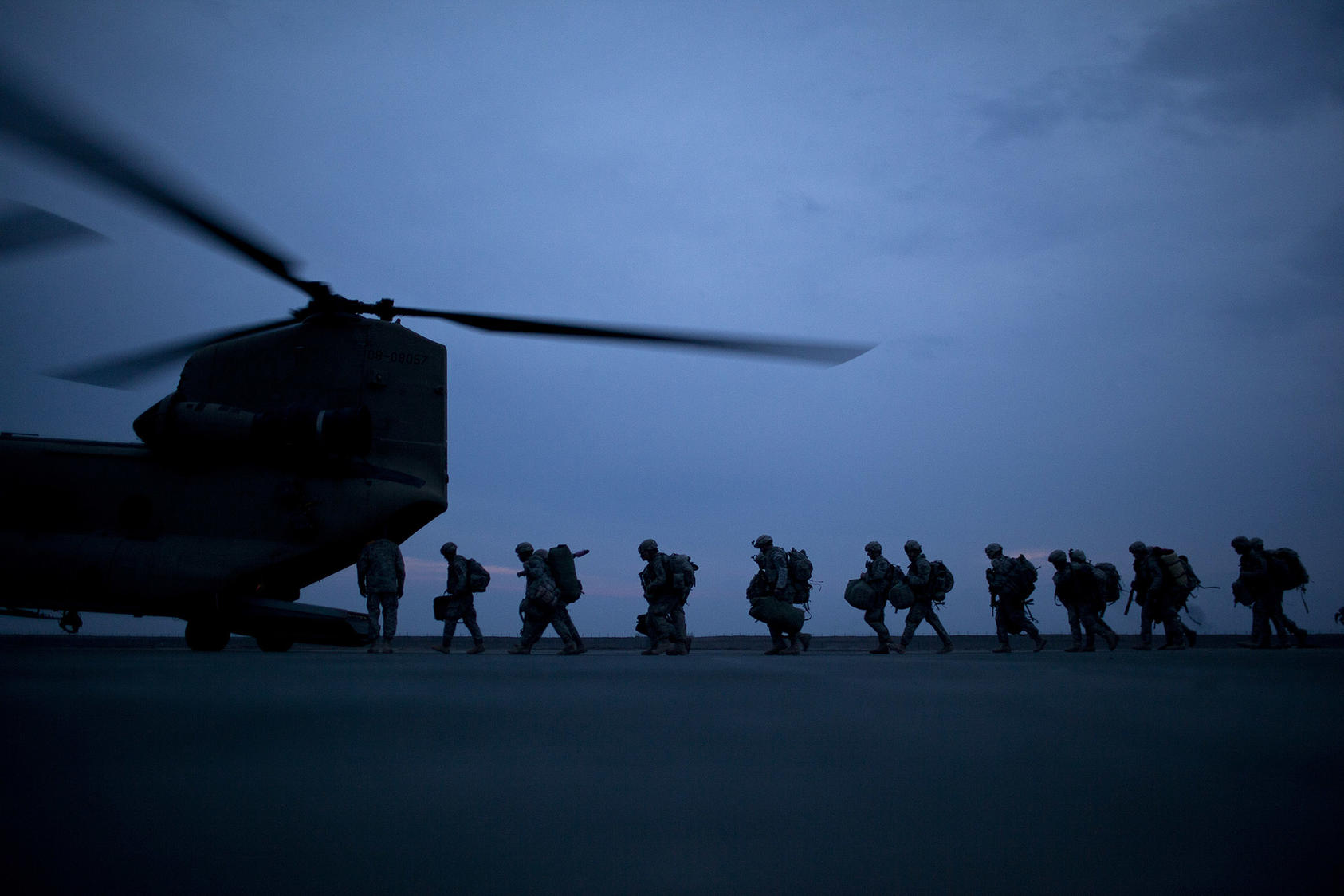 Soldiers board a transport helicopter at a base in Kunduz, Afghanistan.